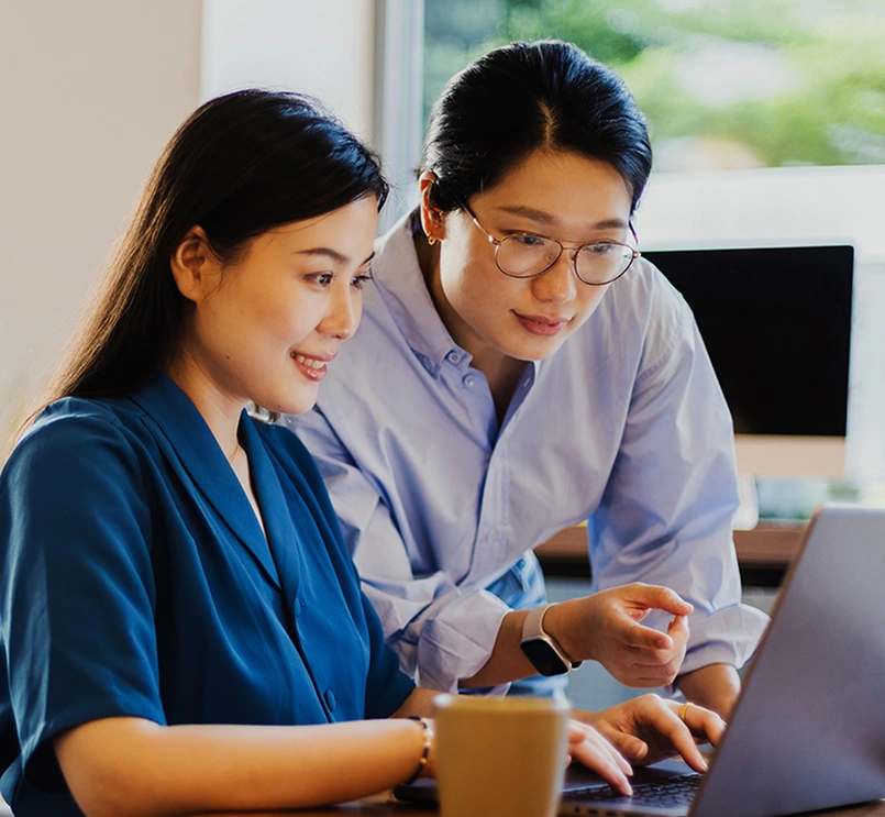 Two colleagues working together on a laptop